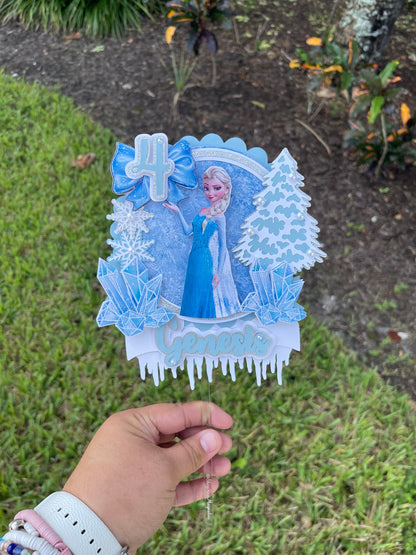 Frozen-themed cake topper. Frozen-inspired topper decoration for parties. Frozen decoration for party.  Sparkling Frozen-themed party decoration. Custom Frozen-themed cake topper . Frozen-inspired  party prop. Shimmery cake topper Elsa themed.