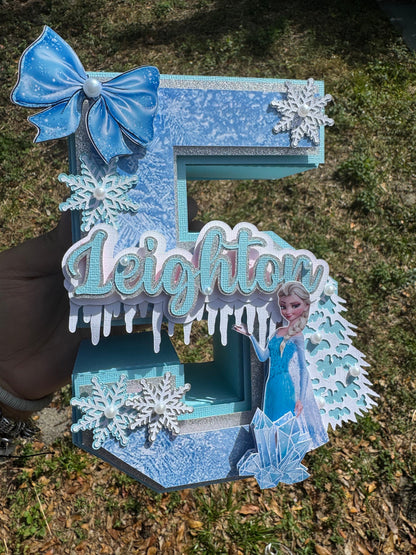 3D Frozen-themed letter party prop. Frozen-inspired letter decoration for parties. Frozen letter prop for themed celebrations. Sparkling Frozen-themed party decoration. Custom Frozen-themed party prop. Frozen-inspired 3D party prop.3D Number .